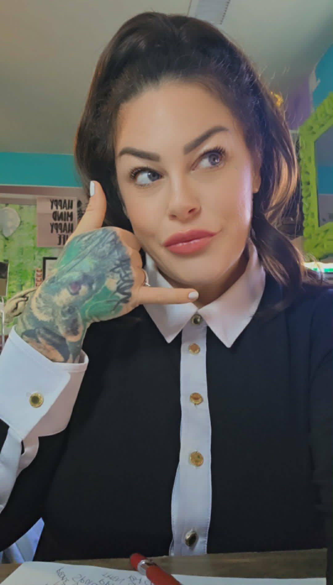 Lindsay making a phone-call hand gesture